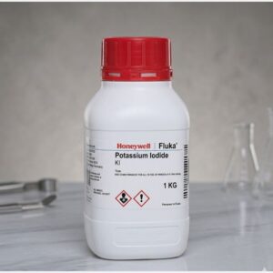 Front view of Kimyai Potassium Iodide Chemical product potassium iodide container with red cap placed on laboratory surface near glass flasks and tools