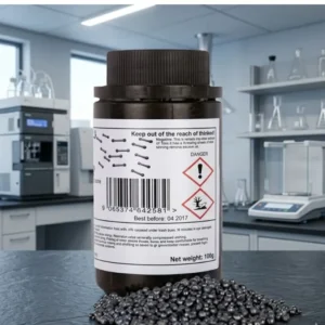 A dark brown chemical bottle of Iodine Chemical with a pile of dark gray crystalline prills in front, centered against a blurred, modern laboratory background.