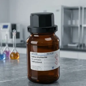 An amber glass bottle of Iodine Trichloride Chemical with a black safety cap, centered against a blurred, modern laboratory background.