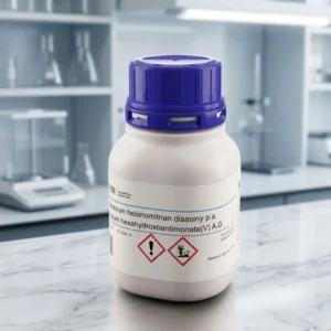 A white chemical bottle of Potassium hexa antimonate chemical with a blue cap, centered against a blurred, modern laboratory background.